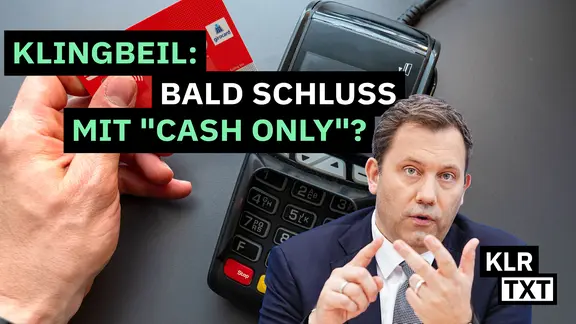 Lars Klingbeil vor dem Hintergrund eines Kartenlesegerätes.