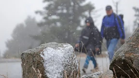 Wanderer wandern durch den Schnee auf dem Brocken