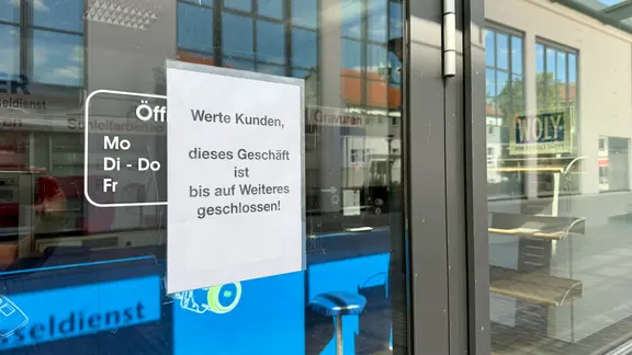Ein Schild an einer Ladentür.