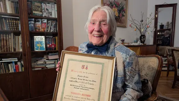 GGisela Schöbel-Graß  hält eine Weltrekord-Urkunde in den Händen.