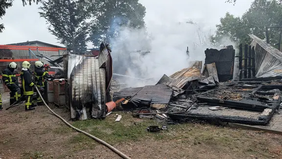 Feuerwehrmänner vor einem zerstörten Wohnhaus