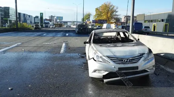 Ein russischer Luftangriff hat eine Schnellstraße in der Nähe von Kiew getroffen. Mehrere Menschen sind dabei getötet worden. Ein beschädigtes Auto steht auf der Straße. 
