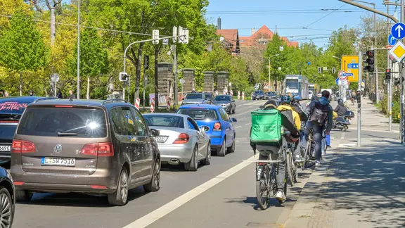 Autos und Fahrräder auf einer vielbefahrenen Straße