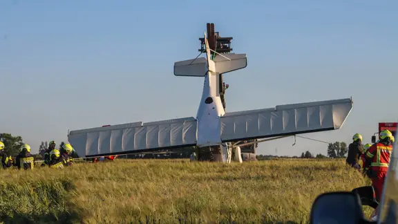 Flugzeug steckt kopfüber in Feld