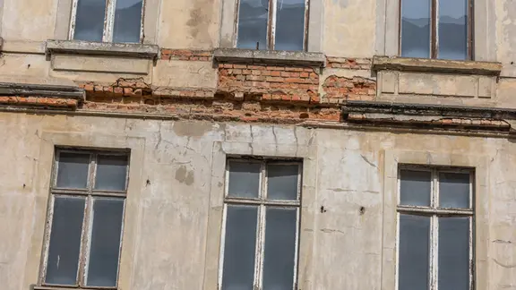Ein leerstehendes Wohnhaus mit maroder Fassade